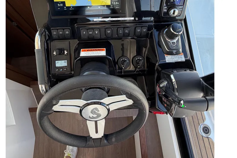 Slide: The Image of Steering console of 2026 Beneteau Antares 9 with navigation controls and display. - 26