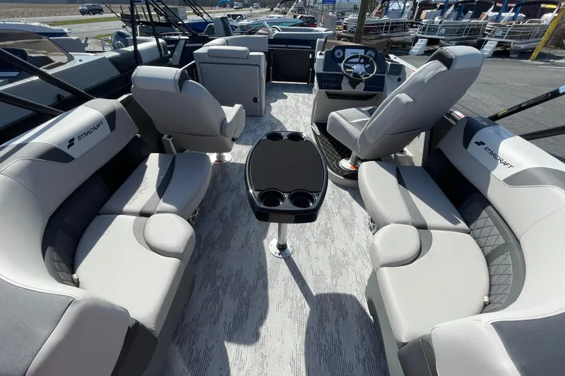 Slide: The Image of 2026 Starcraft SLS 1 boat interior with modern seating and steering console. - 15
