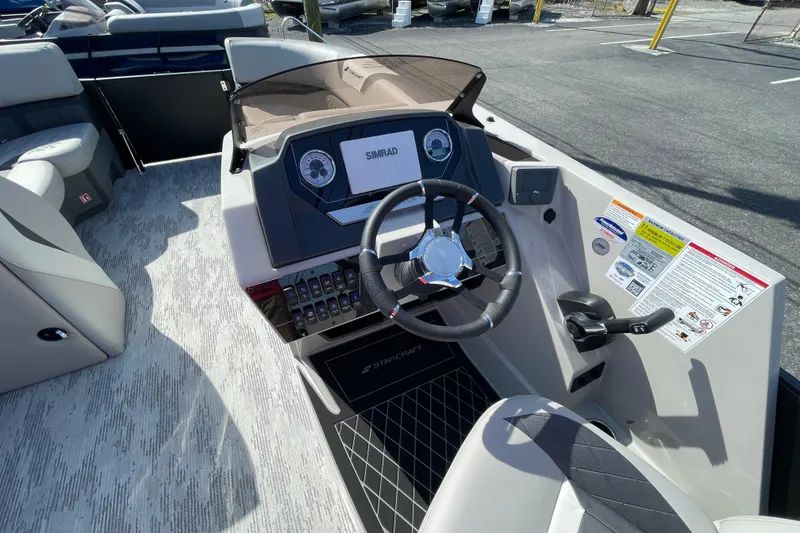 Slide: The Image of 2026 Starcraft SLS 1 boat dashboard with steering wheel and control panel. - 7