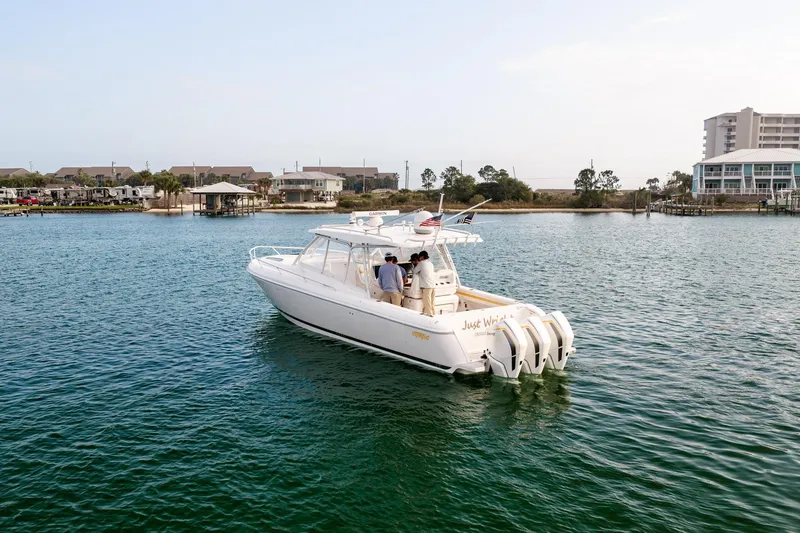 Slide: The Image of 2020 Intrepid 407 Cuddy cruising on a scenic waterway with passengers onboard. - 10