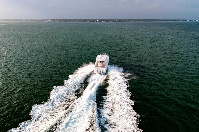 Slide: The Image of 2020 Intrepid 407 Cuddy cruising on open water at sunset. - 17