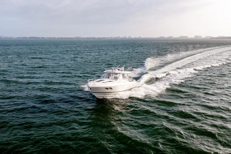 Slide: The Image of 2020 Intrepid 407 Cuddy cruising on open water, showcasing sleek design and performance. - 20