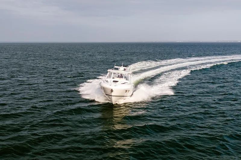 Slide: The Image of Aerial view of 2020 Intrepid 407 Cuddy boat cruising on open water. - 22