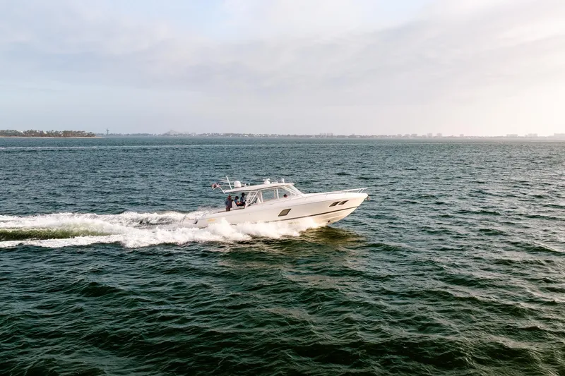 Slide: The Image of 2020 Intrepid 407 Cuddy cruising swiftly on open water. - 23