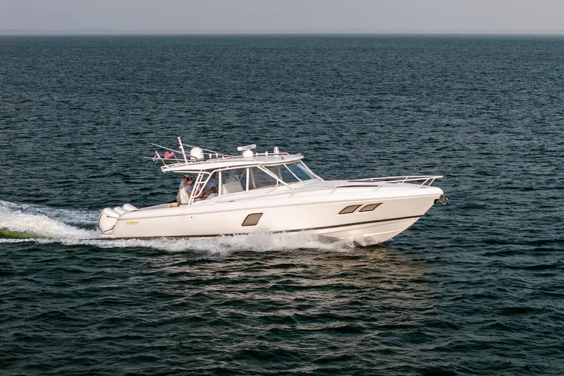 Slide: The Image of Aerial view of 2020 Intrepid 407 Cuddy boat cruising on open water. - 26