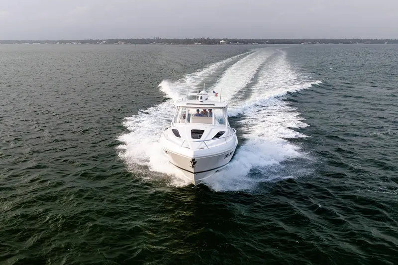 Slide: The Image of Aerial view of 2020 Intrepid 407 Cuddy boat cruising on open water. - 30