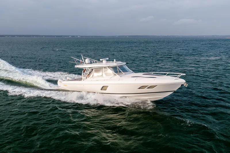 Slide: The Image of 2020 Intrepid 407 Cuddy cruising on open water, showcasing sleek design and performance. - 33