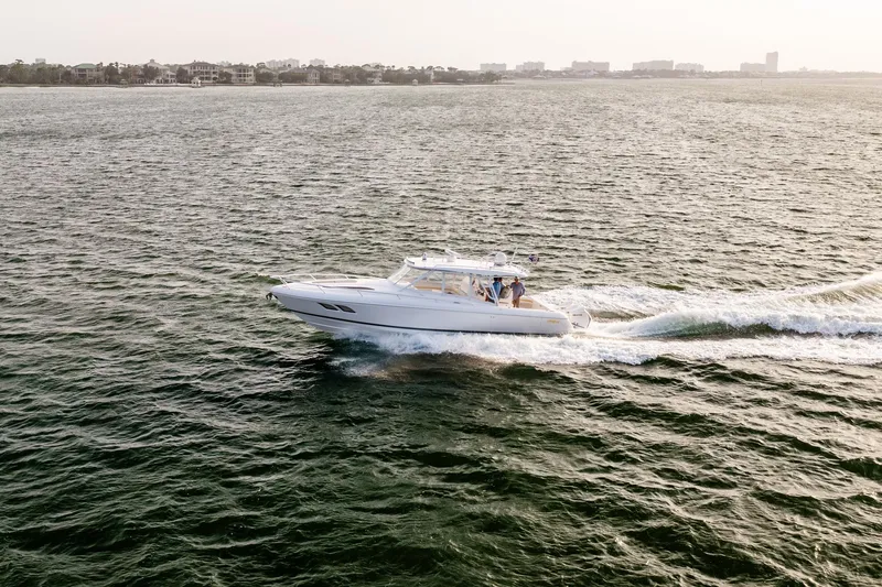 Slide: The Image of 2020 Intrepid 407 Cuddy cruising on open water, showcasing sleek design and performance. - 34