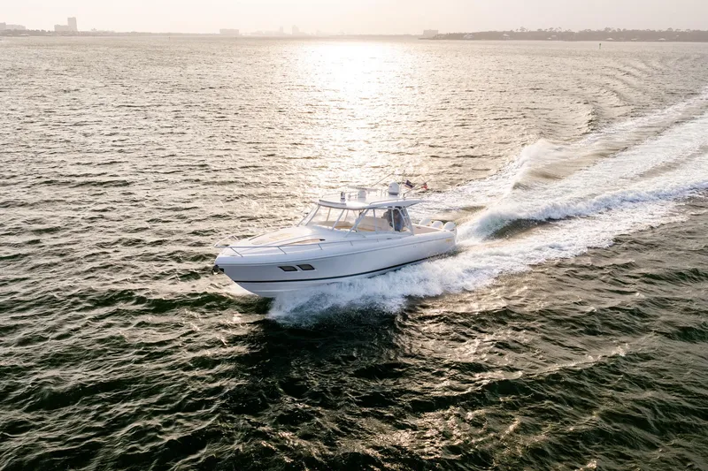 Slide: The Image of 2020 Intrepid 407 Cuddy cruising on open water at sunset. - 35