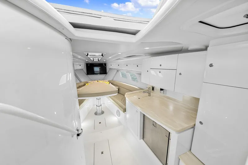 Slide: The Image of Interior of 2020 Intrepid 407 Cuddy boat with modern kitchen and seating area. - 37