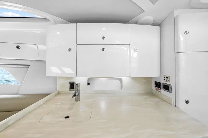 Slide: The Image of Modern kitchen area in 2020 Intrepid 407 Cuddy boat with sleek white cabinetry. - 43