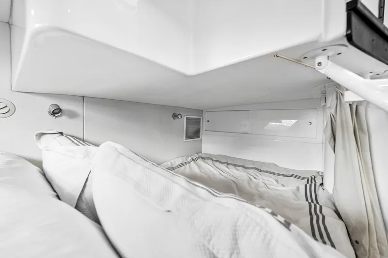 Slide: The Image of 2020 Intrepid 407 Cuddy cabin interior with cozy bedding and modern design. - 45