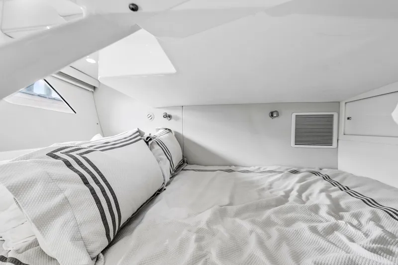 Slide: The Image of 2020 Intrepid 407 Cuddy cabin interior with cozy bedding and modern design. - 46
