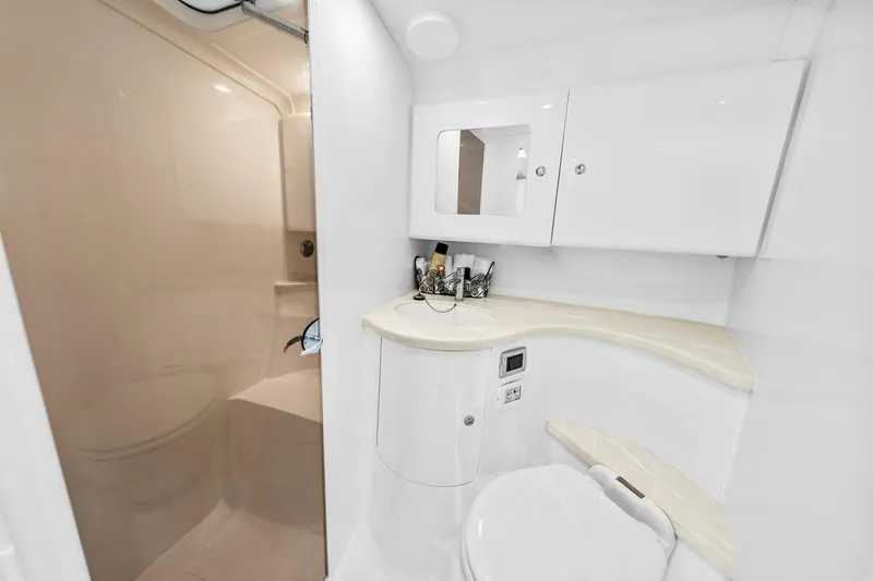 Slide: The Image of 2020 Intrepid 407 Cuddy boat bathroom with modern white fixtures and compact design. - 48