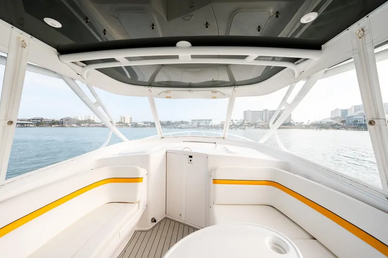 Slide: The Image of 2020 Intrepid 407 Cuddy boat interior with waterfront view, featuring sleek seating and modern design. - 49