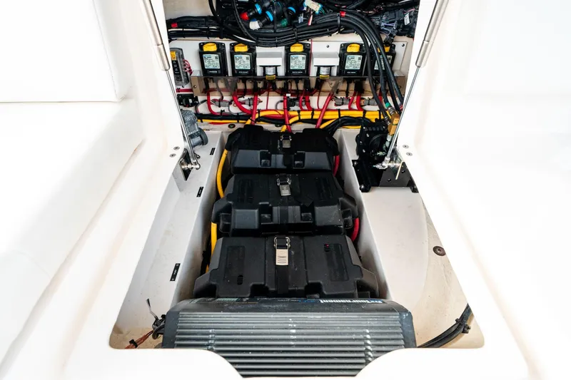 Slide: The Image of Battery compartment of 2020 Intrepid 407 Cuddy boat, showcasing wiring and components. - 51