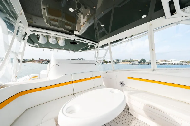 Slide: The Image of 2020 Intrepid 407 Cuddy boat interior with white seating and yellow accents. - 53