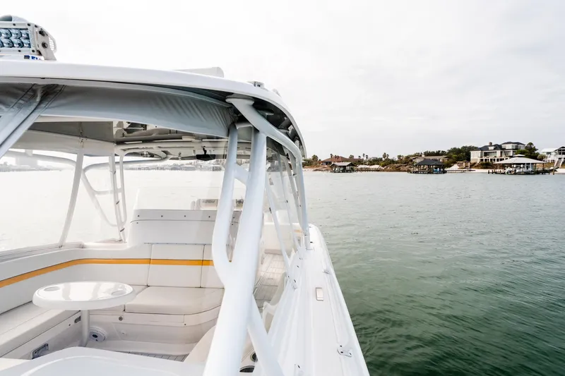 Slide: The Image of 2020 Intrepid 407 Cuddy boat cruising near waterfront homes on a calm day. - 55