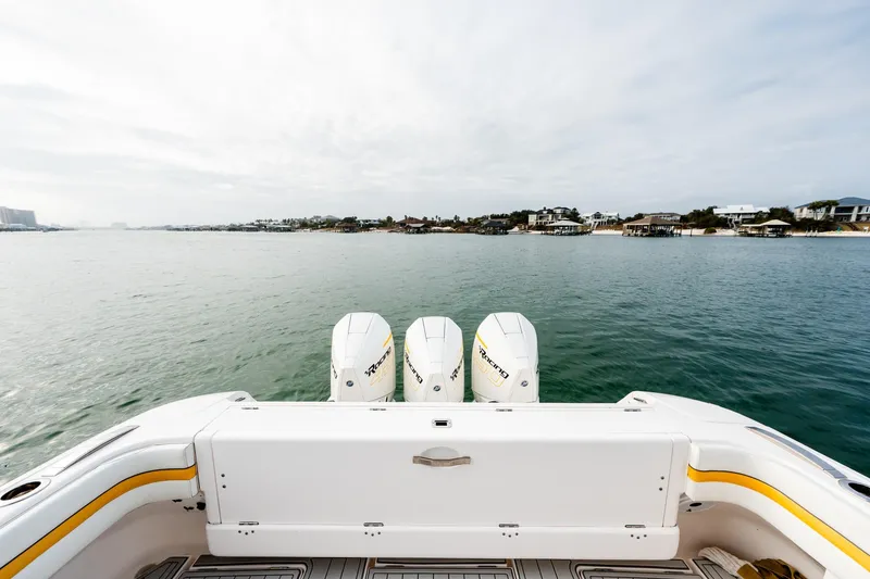 Slide: The Image of 2020 Intrepid 407 Cuddy boat with triple engines on calm water. - 57