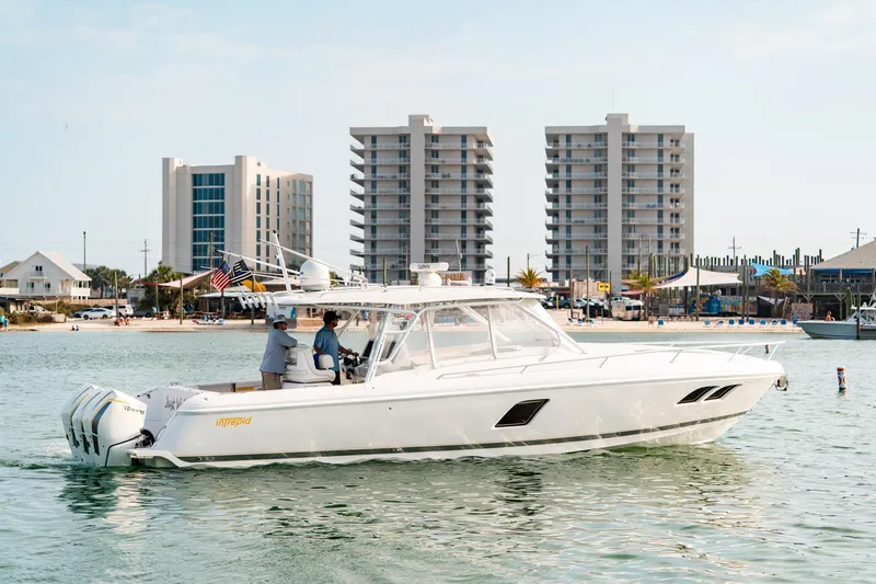 Slide: The Image of 2020 Intrepid 407 Cuddy boat on water with cityscape background. - 6
