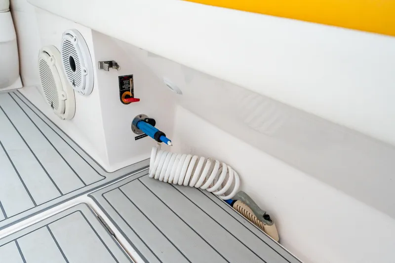 Slide: The Image of 2020 Intrepid 407 Cuddy boat deck with coiled hose and speaker system. - 61