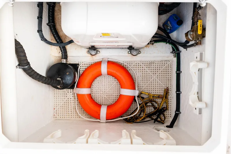 Slide: The Image of Storage compartment of 2020 Intrepid 407 Cuddy with life preserver and equipment. - 63