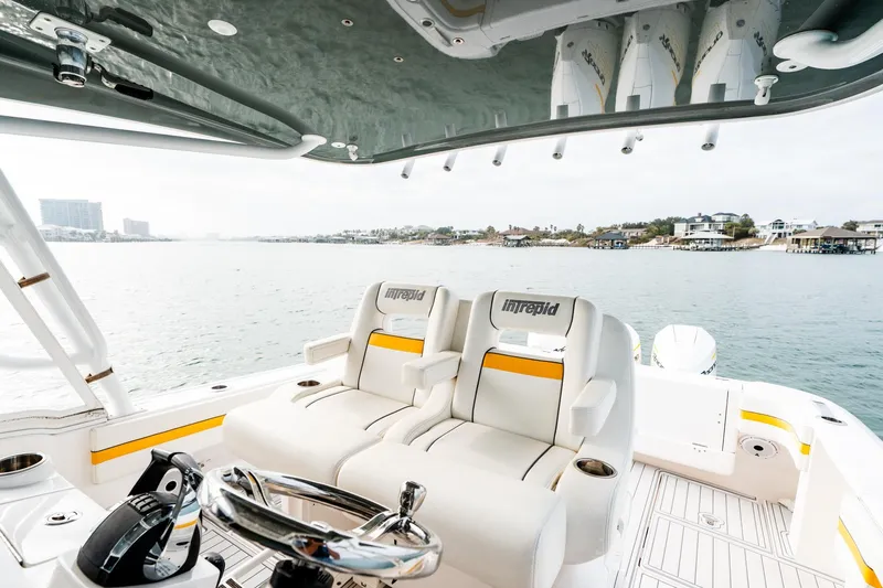 Slide: The Image of 2020 Intrepid 407 Cuddy boat interior with luxurious seating and scenic water view. - 64