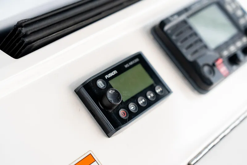 Slide: The Image of Close-up of 2020 Intrepid 407 Cuddy boat dashboard with Fusion audio controls. - 70