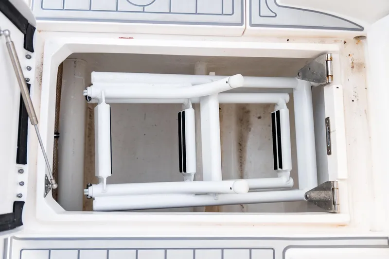 Slide: The Image of Foldable ladder in storage compartment of 2020 Intrepid 407 Cuddy boat. - 76