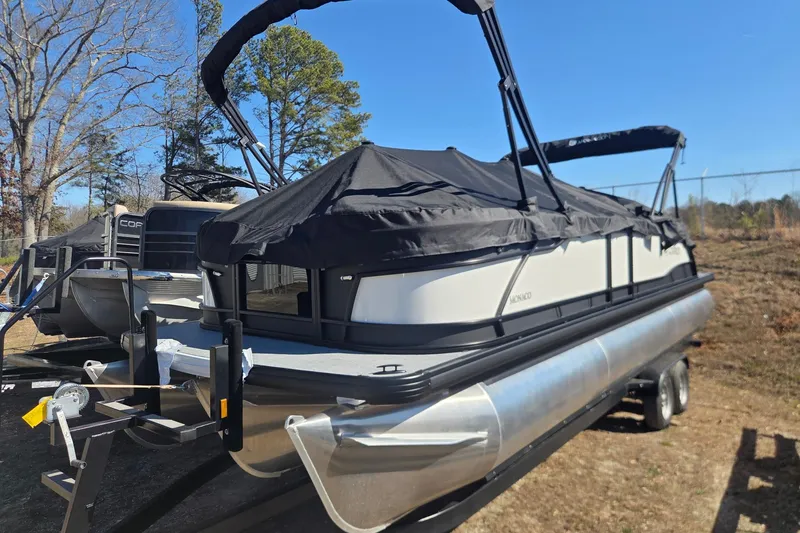 Slide: The Image of 2026 Godfrey Monaco 255 QS pontoon boat with black cover on a trailer. - 6