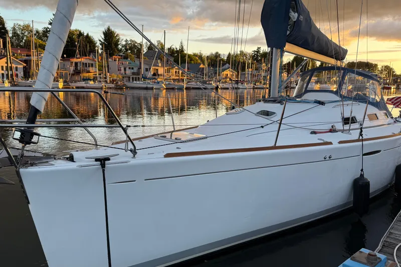 The Image of 2004 Beneteau First 36.7 sailboat docked at marina during sunset. - 0