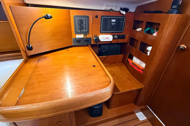 Slide: The Image of Interior of 2004 Beneteau First 36.7 sailboat with navigation station and wooden cabinetry. - 11