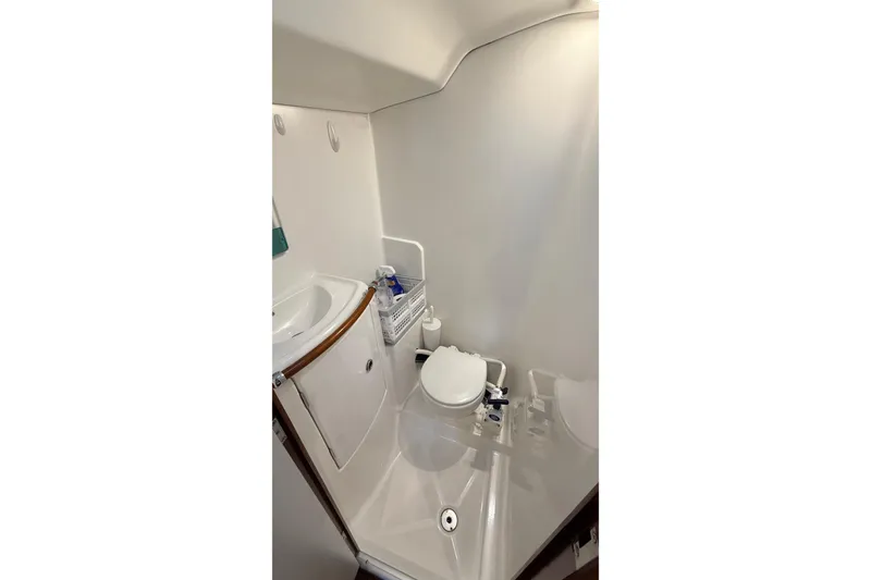Slide: The Image of Compact bathroom in 2004 Beneteau First 36.7 sailboat, featuring sink and toilet. - 12
