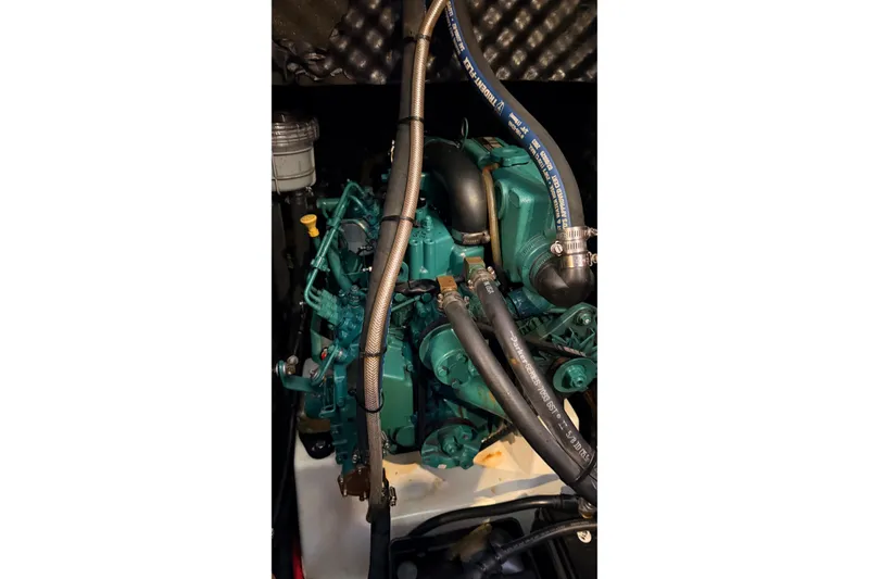 Slide: The Image of Engine of a 2004 Beneteau First 36.7 sailboat, showcasing hoses and components. - 14