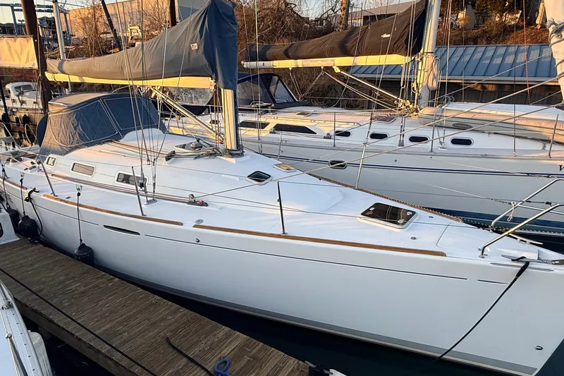 Slide: The Image of 2004 Beneteau First 36.7 sailboat docked at marina, side view. - 17