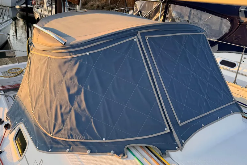 Slide: The Image of Beneteau First 36.7 (2004) sailboat with blue canvas cover in marina. - 20