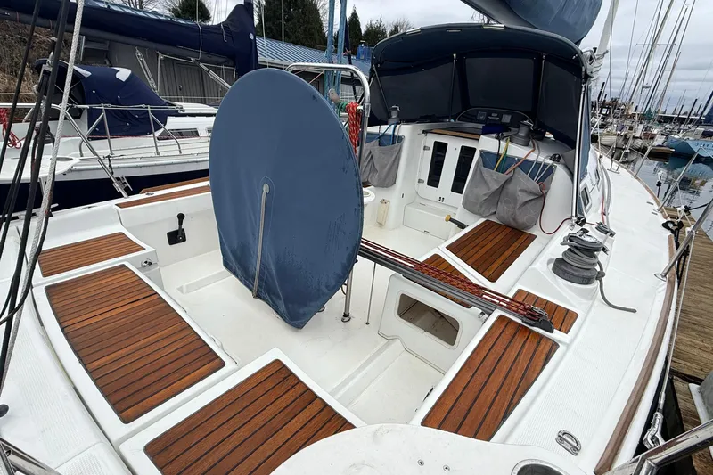 Slide: The Image of 2004 Beneteau First 36.7 sailboat cockpit with teak flooring and covered wheel. - 21