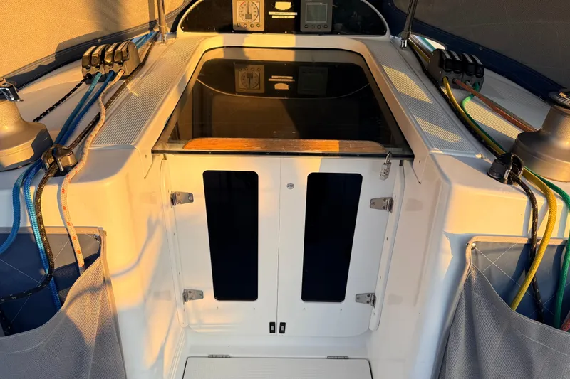 Slide: The Image of 2004 Beneteau First 36.7 yacht cockpit with ropes and winches in sunlight. - 23