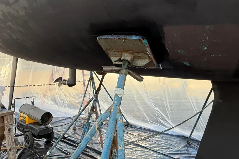 Slide: The Image of Beneteau First 36.7 (2004) sailboat under maintenance with support stands and heater. - 28
