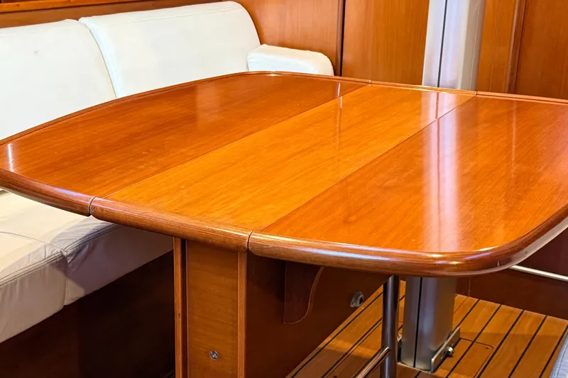 Slide: The Image of Wooden interior of 2004 Beneteau First 36.7 yacht with polished table and seating. - 3