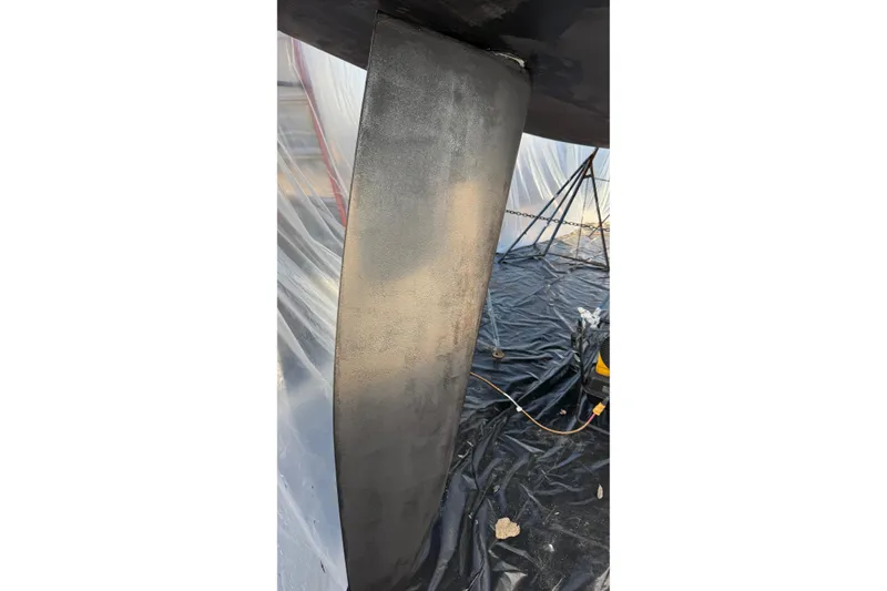 Slide: The Image of Keel of 2004 Beneteau First 36.7 sailboat under maintenance in a covered area. - 30
