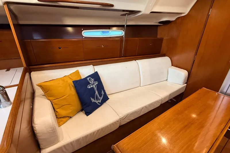 Slide: The Image of Interior of 2004 Beneteau First 36.7 yacht with white sofa and nautical-themed cushions. - 4