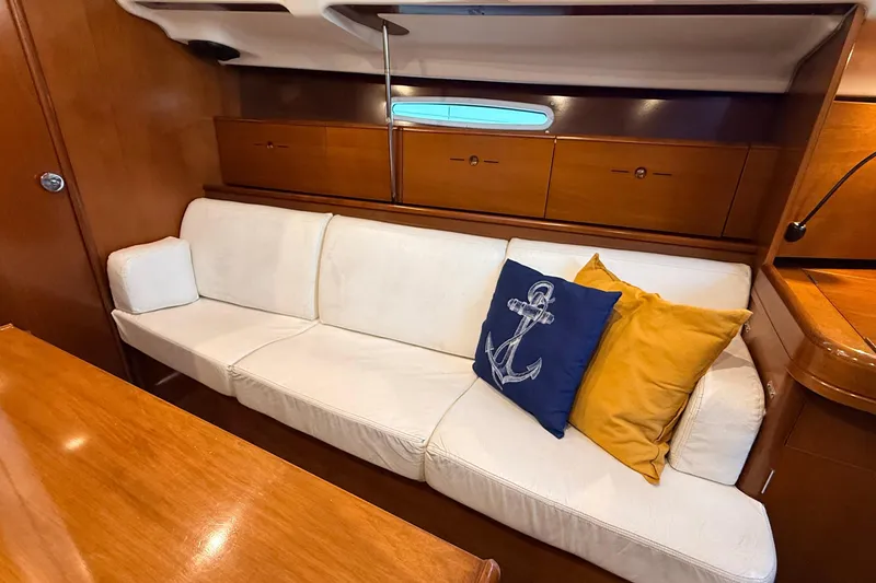 Slide: The Image of Luxurious interior of 2004 Beneteau First 36.7 yacht with white sofa and nautical-themed pillows. - 5