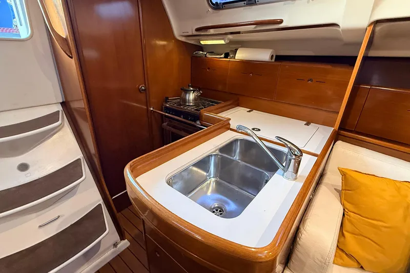Slide: The Image of 2004 Beneteau First 36.7 yacht interior with kitchen sink and stove. - 8