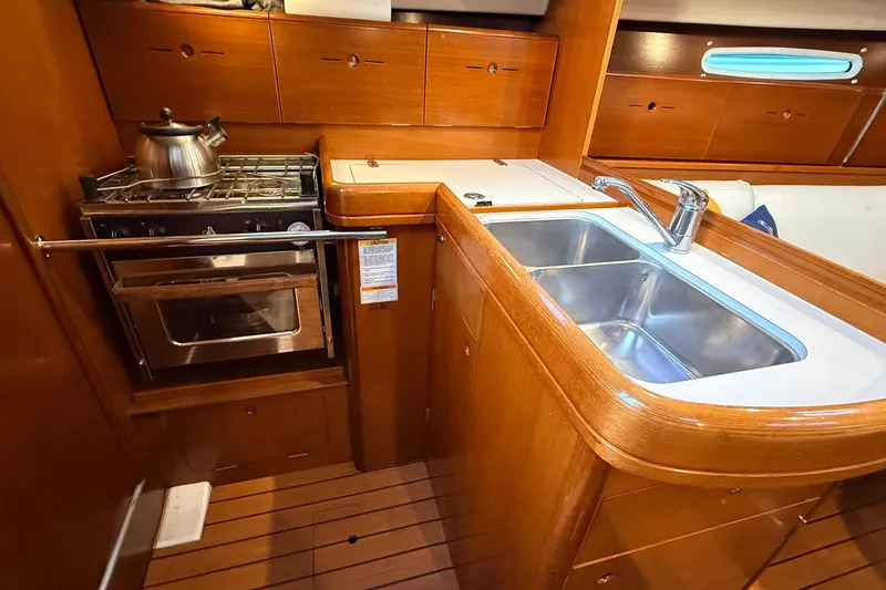 Slide: The Image of 2004 Beneteau First 36.7 yacht kitchen with stove, oven, and double sink. - 9