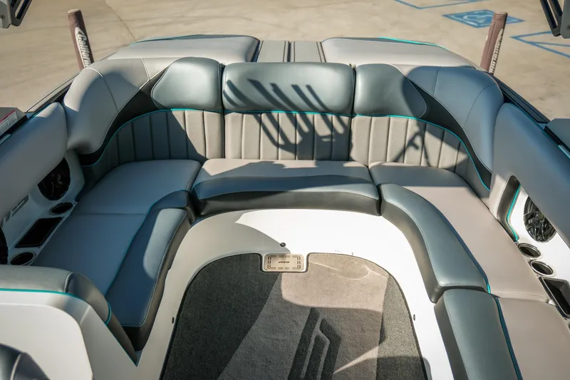 Slide: The Image of 2019 MB B52 23 Classic boat interior with gray seating and teal accents. - 16