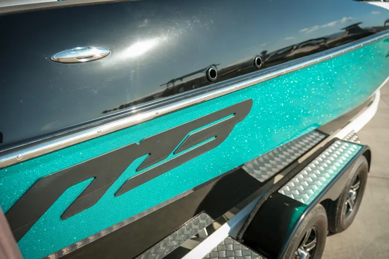 Slide: The Image of 2019 MB B52 23 Classic boat with teal glitter finish on a trailer. - 21