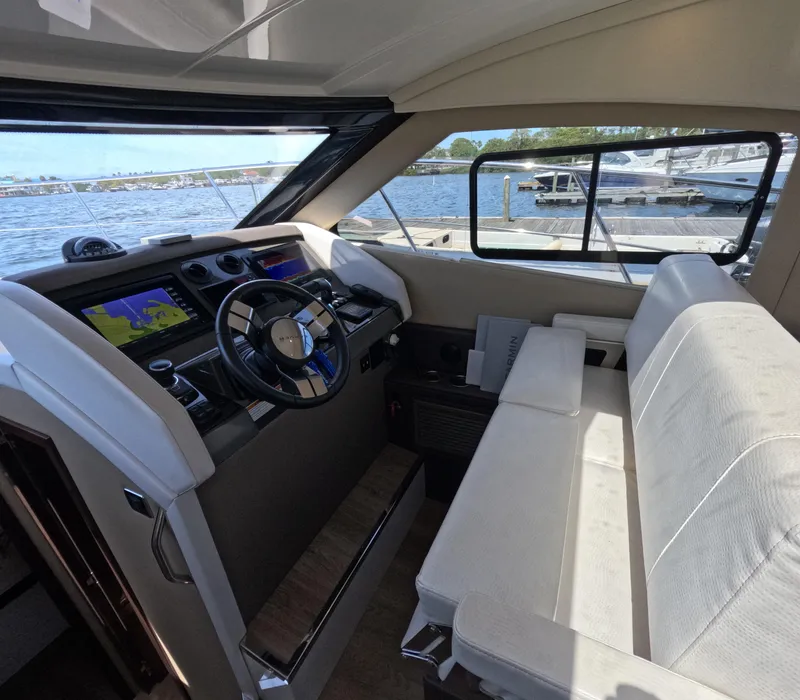 Slide: The Image of Interior of 2019 Carver C37 Coupe yacht with steering wheel and navigation screens. - 10