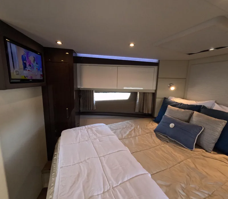 Slide: The Image of Interior of 2019 Carver C37 Coupe with cozy bed, TV, and modern lighting. - 14