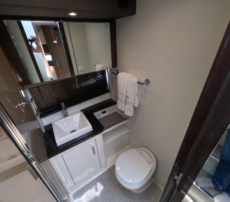 Slide: The Image of Luxurious bathroom in 2019 Carver C37 Coupe yacht with modern fixtures and elegant design. - 16